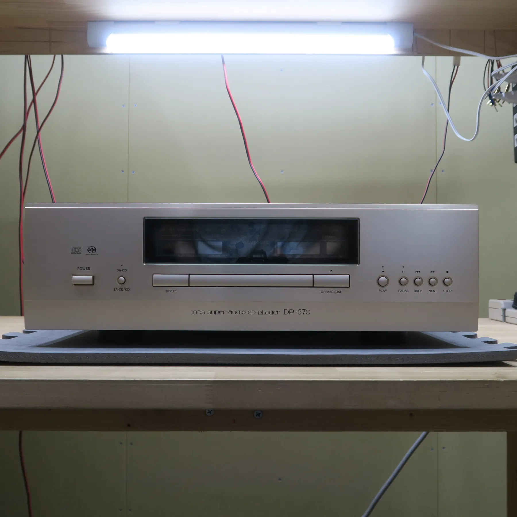 アキュフェーズ DP-570 CDデッキの正面、シルバー系ヘアライン仕上げ前面パネル、電源、SA-CD/CD切替、入力切替、開閉、再生、一時停止、戻る、次へ、停止